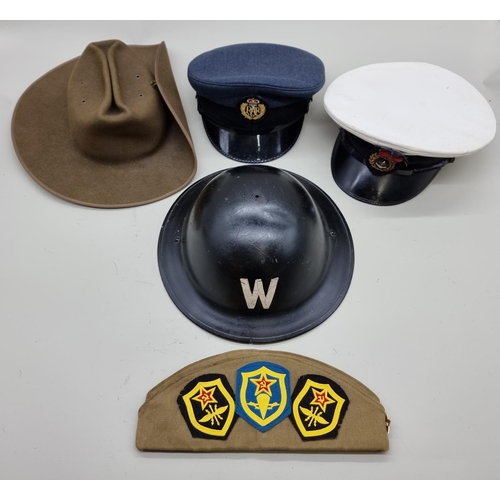 1728 - A Royal Navy officer's cap; together with an RAF cap; a World War II ARP warden's steel helmet, date... 