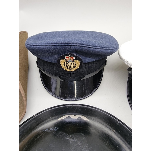 1728 - A Royal Navy officer's cap; together with an RAF cap; a World War II ARP warden's steel helmet, date... 