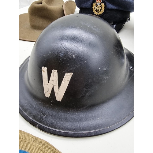 1728 - A Royal Navy officer's cap; together with an RAF cap; a World War II ARP warden's steel helmet, date... 