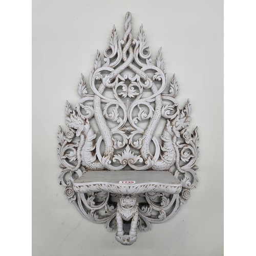 1735 - An Indonesian grey painted carved wood wall bracket, 58cm high. 