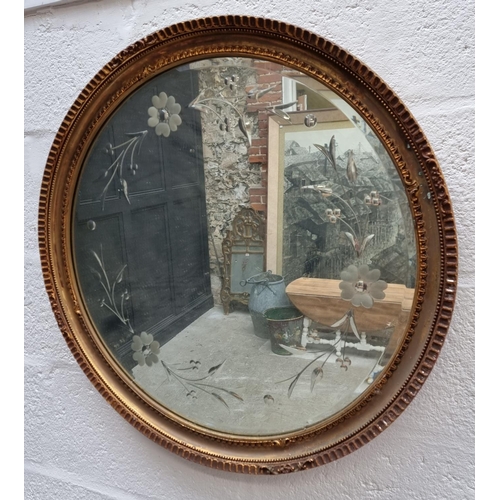 1741 - A gilt framed etched wall mirror, 72 x 100.5cm; together with a similar circular example, 70.5c... 