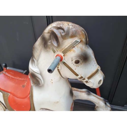 1746 - A vintage tinplate child's sprung rocking horse, 89cm high; together with another push along plush d... 