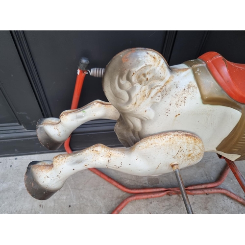 1746 - A vintage tinplate child's sprung rocking horse, 89cm high; together with another push along plush d... 