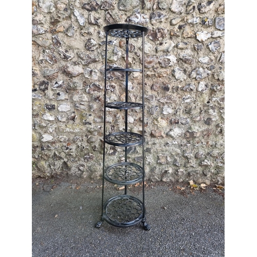 1748 - A black painted metal six tier pan stand, 123cm high.