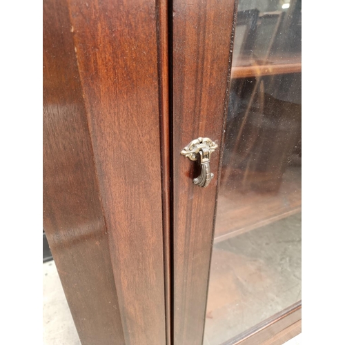 1749 - A mahogany hanging corner display cupboard, 111 x 78.5cm.