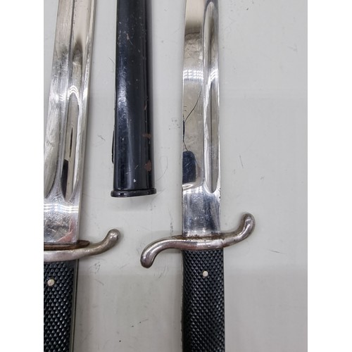 1715A - Two German World War II fireman's bayonets and scabbards; comprising one long pattern, marked 'Solin... 