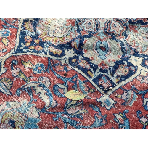 1012 - A Persian carpet, having central floral medallions, with floral cartouches to each corner of ce... 