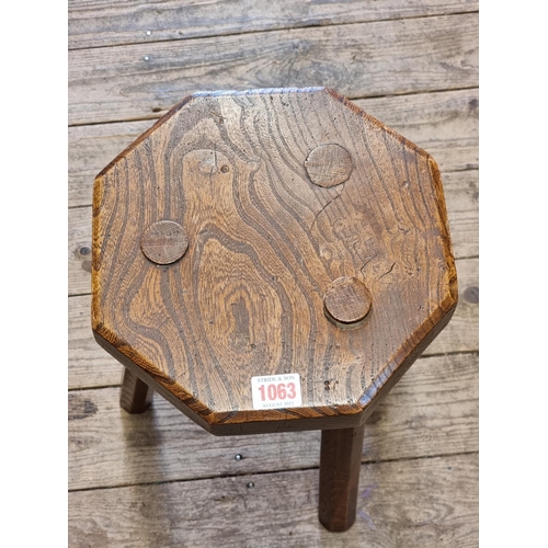 1063 - An antique elm and oak octagonal milking stool, 26.5cm wide.  