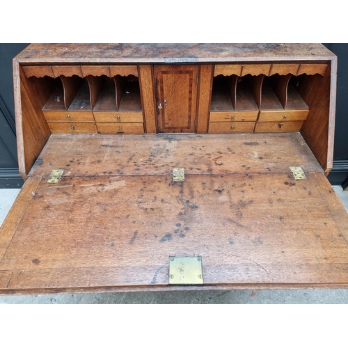 1099 - A George III oak and walnut crossbanded bureau, 106.5cm wide.  