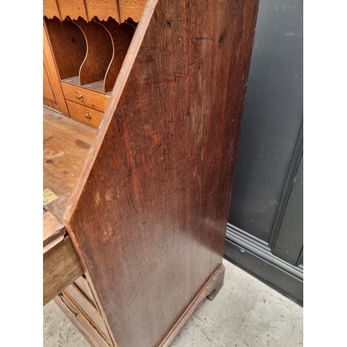 1099 - A George III oak and walnut crossbanded bureau, 106.5cm wide.  