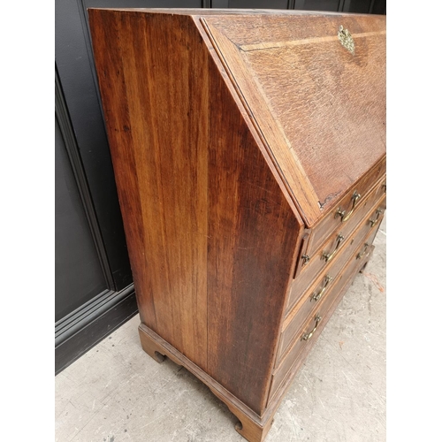 1099 - A George III oak and walnut crossbanded bureau, 106.5cm wide.  