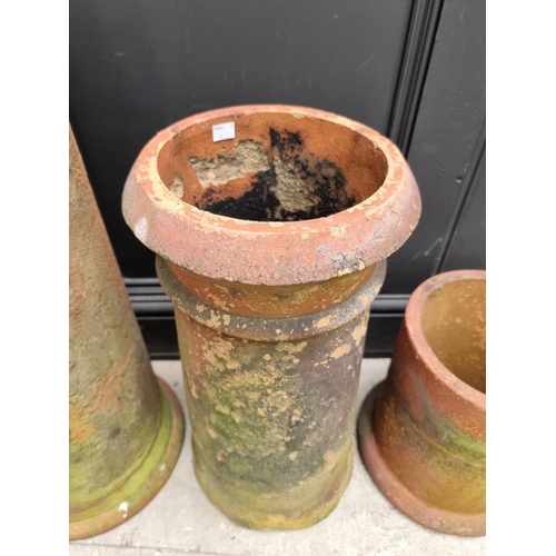 1348 - Four various terracotta chimney pots, largest 76cm high. 