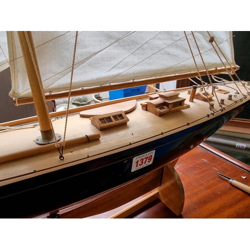 1379 - A wooden J Class pond yacht, 90.5cm long, on stand, (lacking rudder).