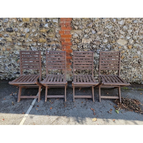 1737 - A set of four folding hardwood garden chairs.