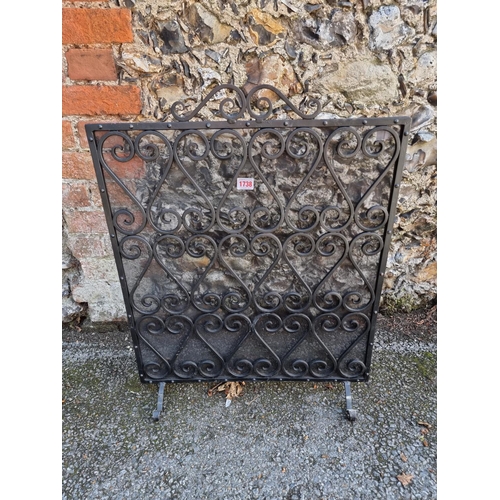 1738 - A black wrought iron firescreen, 71 x 56cm.