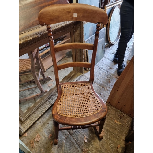 1754 - A Victorian mahogany Pembroke table, 105cm wide; together with a beech and cane rocking chair; ... 