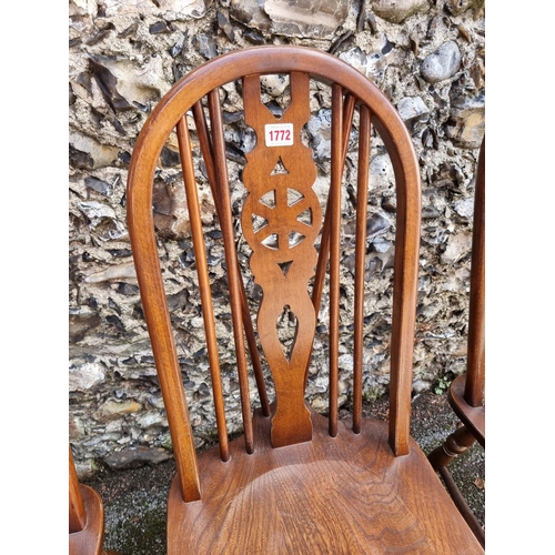 1772 - A set of four Old Charm elm and beech wheelback chairs. 