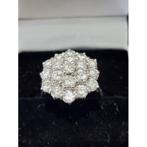 170A - A diamond cluster ring, stamped 18ct, set 19 brilliant cut diamonds totalling approximately 2.8ct, s... 