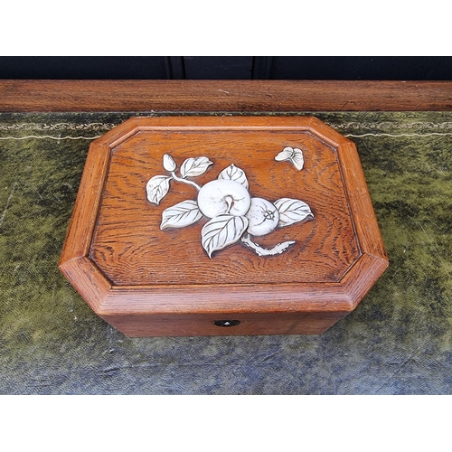 1347 - A Japanese elm and bone casket, of canted rectangular form, 23cm wide.