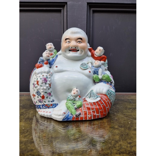 1391 - A Chinese famille rose Buddha and five boys, marked to base, 25cm high.