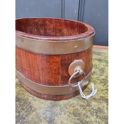 1008 - A 19th century mahogany and brass bound shallow wine cooler or jardiniere, 57.5cm wide.   ... 