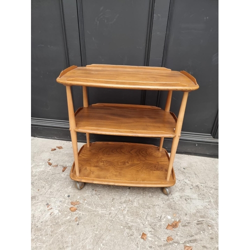 1017 - A vintage Ercol elm three tier trolley, 70cm wide. 