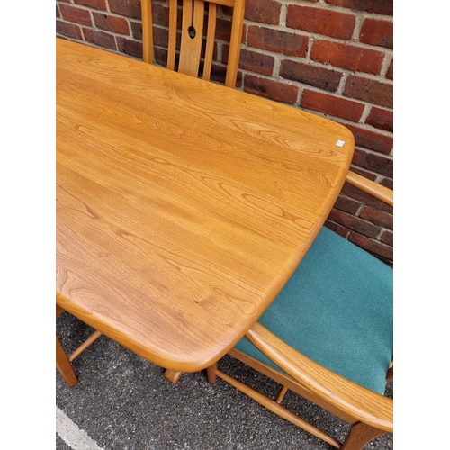 1018 - An Ercol elm dining table and four chairs, to include a pair of elbow chairs, the table 152.5cm long... 