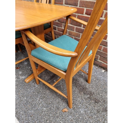 1018 - An Ercol elm dining table and four chairs, to include a pair of elbow chairs, the table 152.5cm long... 