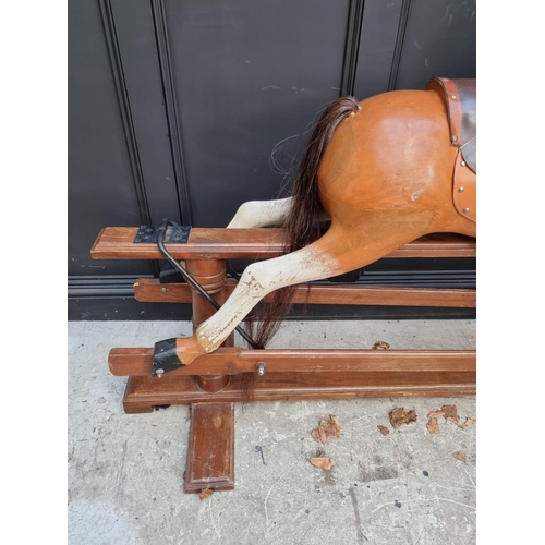 1024 - A large painted wood rocking horse, 165cm long. 