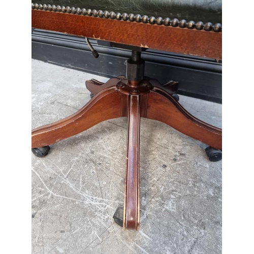 1030 - A reproduction mahogany and green leather desk chair. 