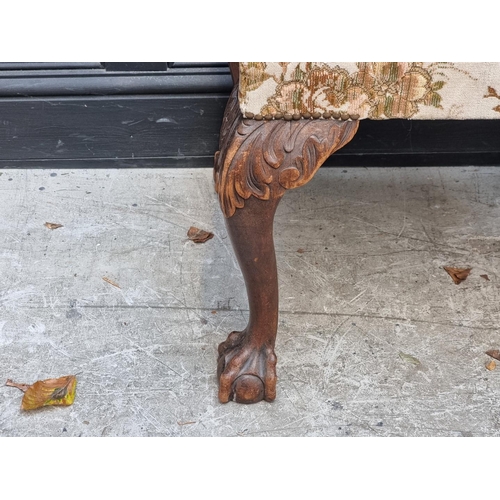 1031 - A 1930s, 18th century style, carved walnut and upholstered stool.