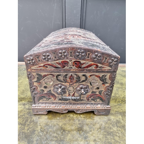 1033 - A small antique embossed leather and brass dome top casket, 44.5cm wide.