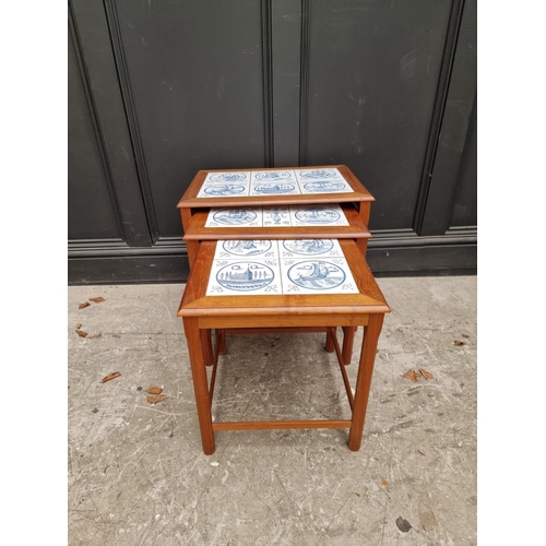 1035 - A nest of three mid-century teak and tile inset occasional tables, largest 56cm wide. ... 