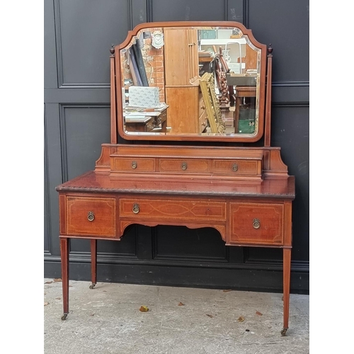 1040 - An Edwardian mahogany and inlaid bedroom suite, comprising: a triple wardrobe, 200.5cm wide; a mirro... 