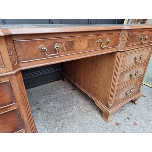 1044 - A reproduction walnut partner's pedestal desk, of inverted breakfront form, 152cm wide.... 