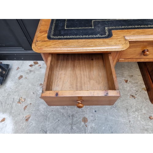 1060 - A late Victorian satin birch inverted breakfront pedestal desk, 121cm wide. ... 