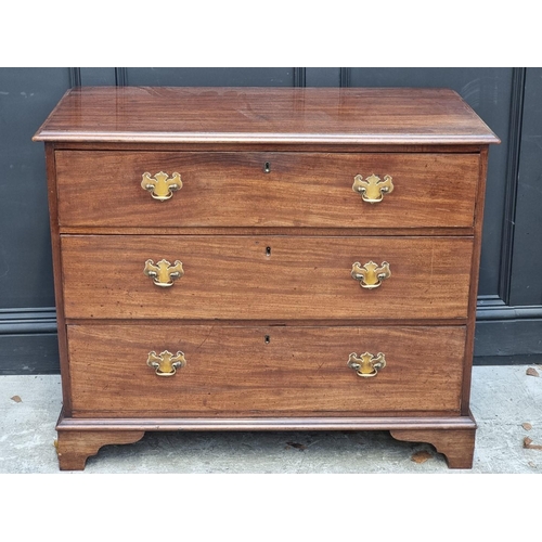 1064 - A George III mahogany chest of three long drawers, 102cm wide.  