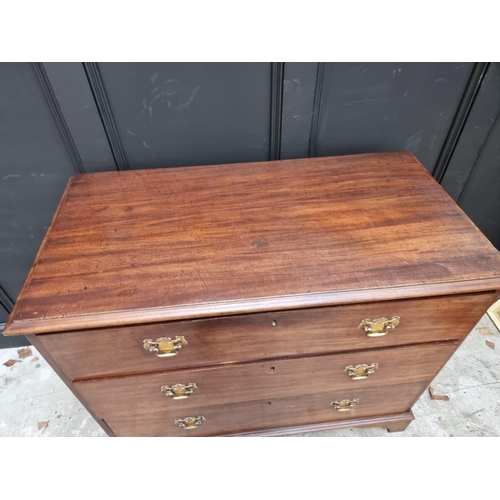 1064 - A George III mahogany chest of three long drawers, 102cm wide.  