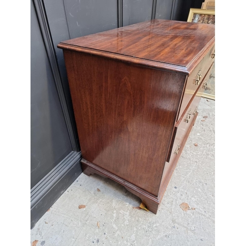 1064 - A George III mahogany chest of three long drawers, 102cm wide.  