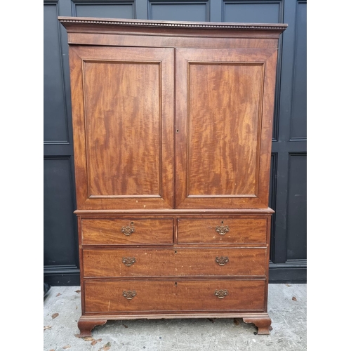 1068 - A George III mahogany linen press, enclosing four sliding trays, 131cm wide.