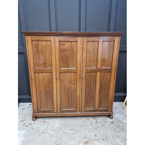 1069 - A small early 20th century mahogany triple wardrobe, 152.5cm wide. 