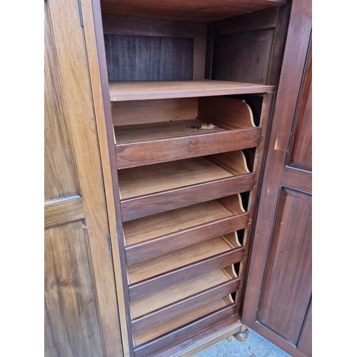 1069 - A small early 20th century mahogany triple wardrobe, 152.5cm wide. 