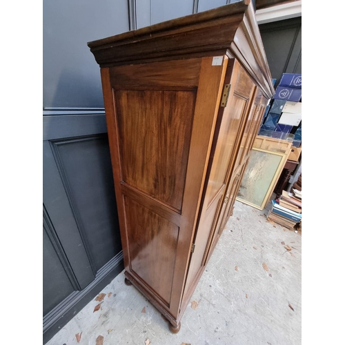 1069 - A small early 20th century mahogany triple wardrobe, 152.5cm wide. 