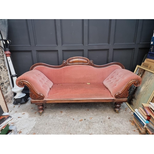 1076 - A Victorian mahogany and button upholstered scroll arm settee, 221cm wide.