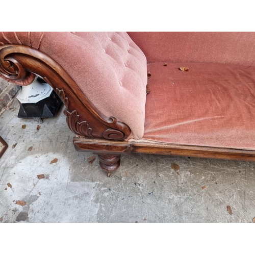 1076 - A Victorian mahogany and button upholstered scroll arm settee, 221cm wide.