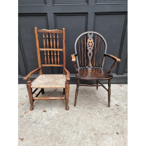 1080 - A small Victorian ash and rush spindle back elbow chair; together with another wheelback chair. (2)... 