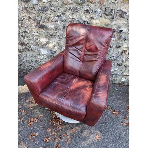 1094 - A red leather revolving occasional chair.