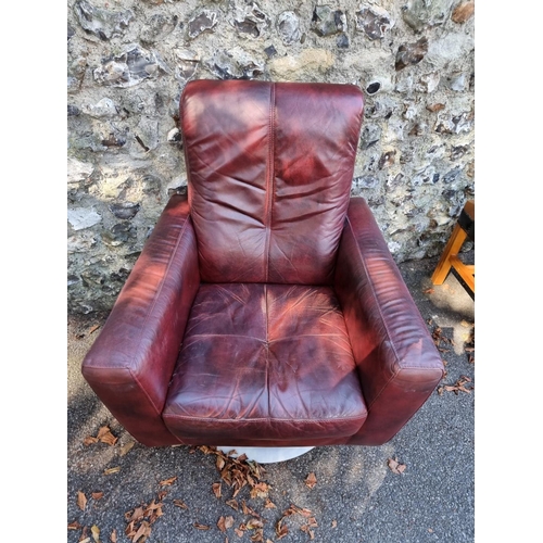 1094 - A red leather revolving occasional chair.