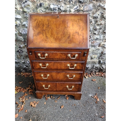 1099 - A small reproduction walnut bureau, 53cm wide; together with a Victorian mahogany bedside cupboard, ... 