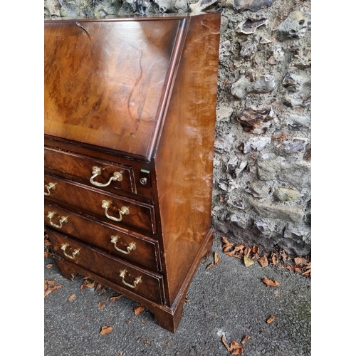 1099 - A small reproduction walnut bureau, 53cm wide; together with a Victorian mahogany bedside cupboard, ... 